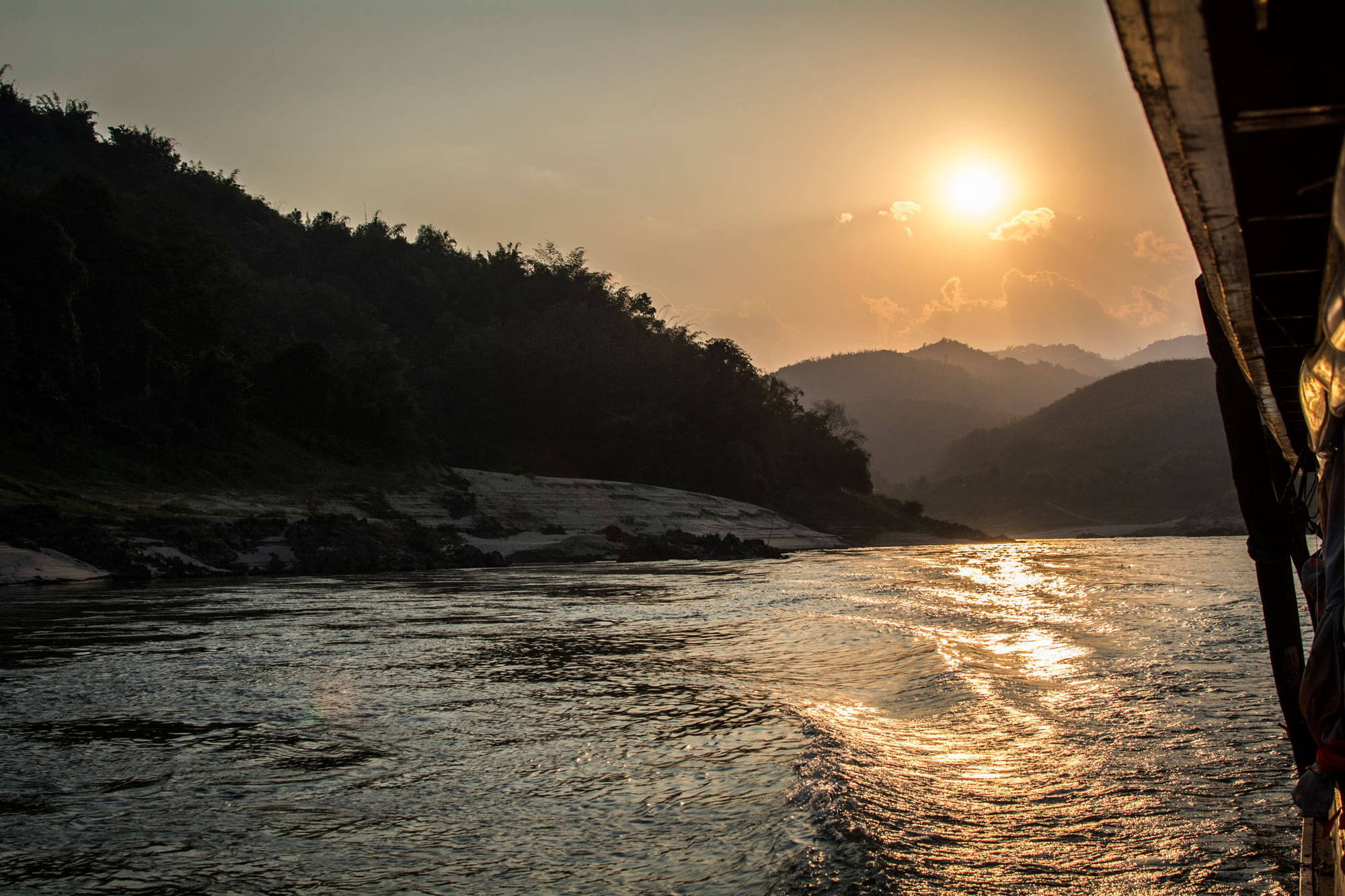 Mekong river slow boat sunset